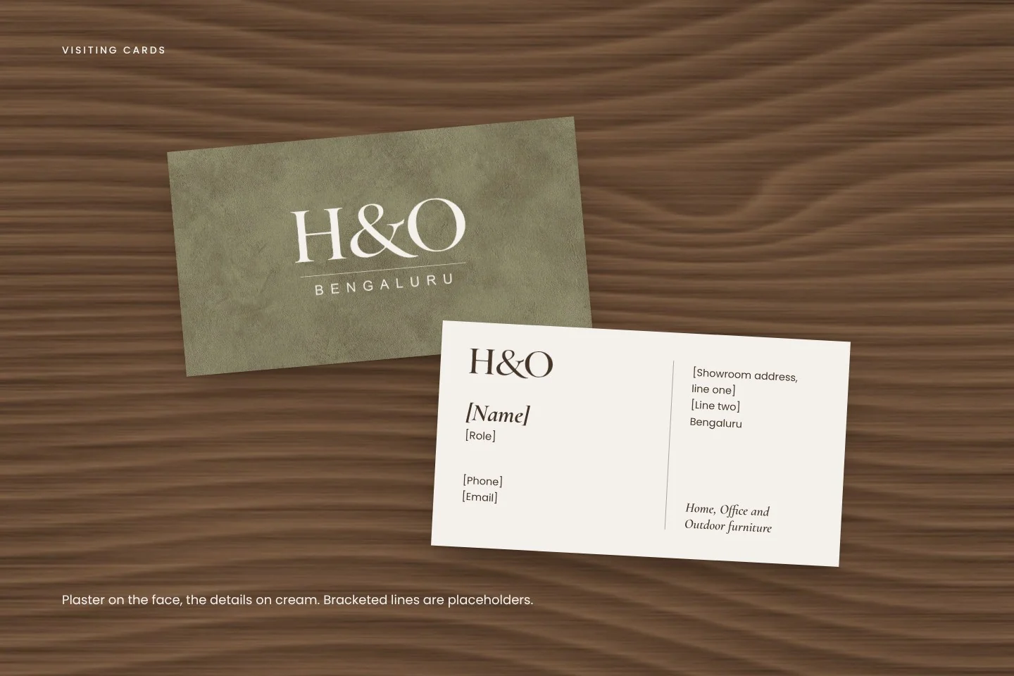 Two visiting cards on walnut: olive plaster with the logo, and cream with the details
